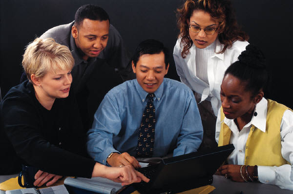 A group of people working together on a laptop